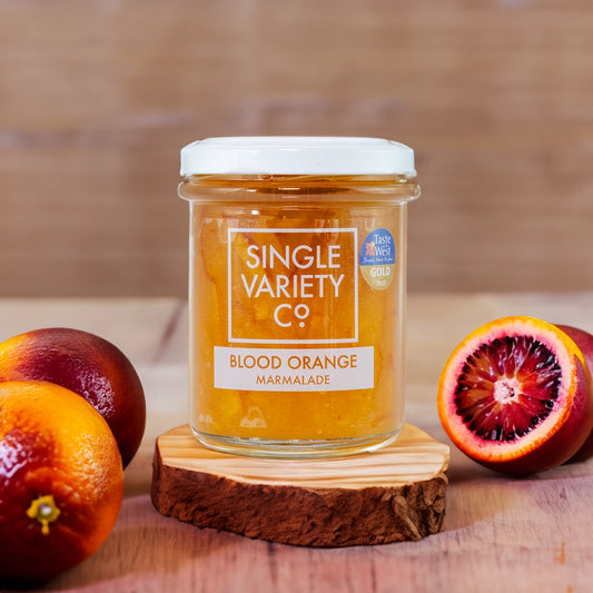 Jar of blood orange marmalade orange on a wooden table 