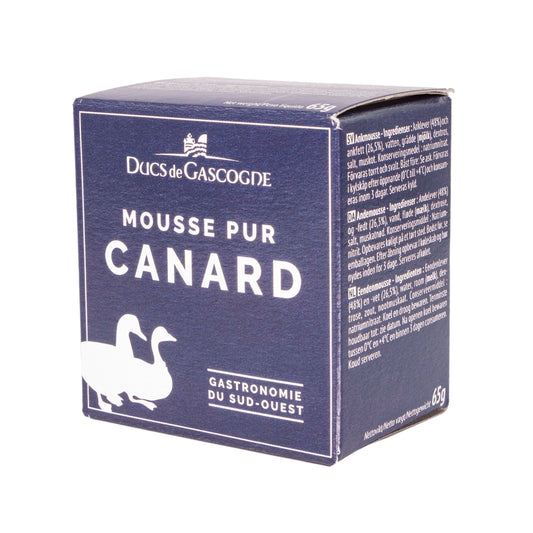 A blue cardboard box featuring two ducks. The label reads "Ducs de Gascogne Mousse Pur Canard Gastronomie du Sud-Ouest" in French, which translates to "Dukes of Gascony: Pure Duck Mousse Gastronomy of the Southwest." 